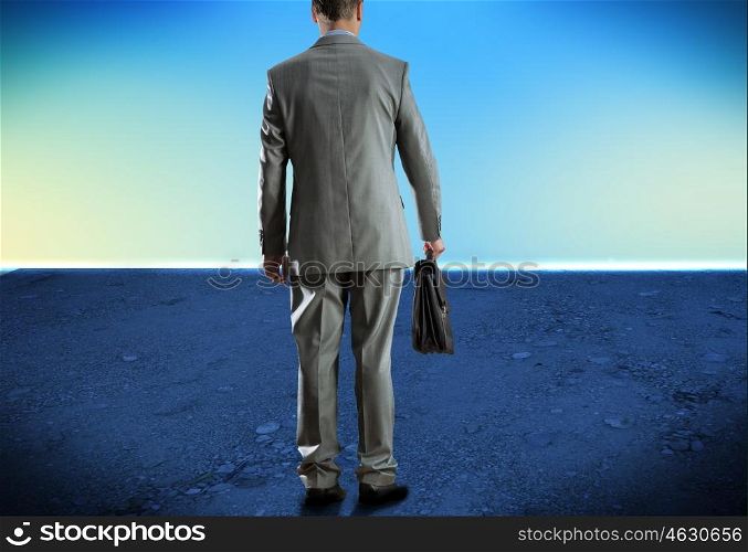 Man with suitcase. Bottom view of businessman with suitcase in hand