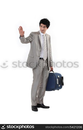 Man with suitcase waving goodbye