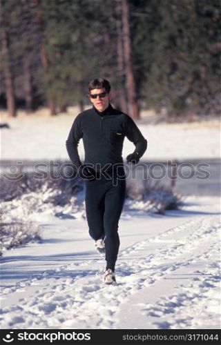 Man With Sunglasses Running in Snow