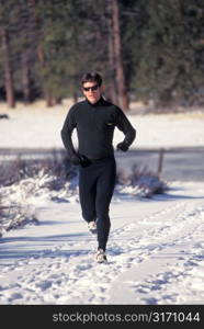 Man With Sunglasses Running in Snow