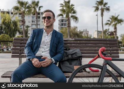 man with sunglasses sitting bench 2