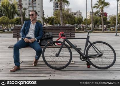 man with sunglasses sitting bench