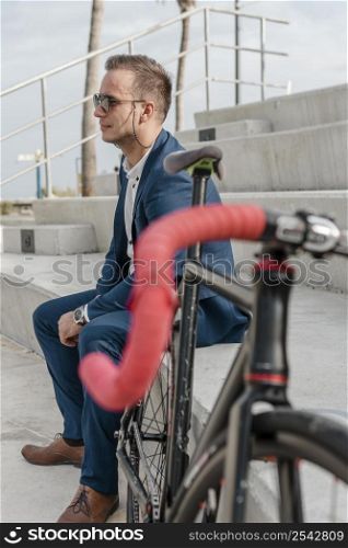 man with sunglasses sitting his bike outdoors