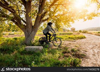 Man with surgical mask in the field with his bicycle during de-escalated in spain by covid-19