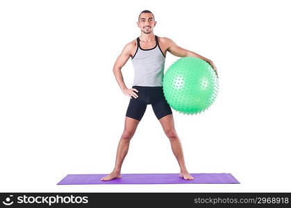 Man with swiss ball doing exercises on white