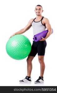 Man with swiss ball doing exercises on white