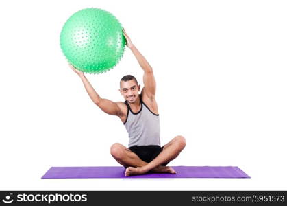 Man with swiss ball doing exercises on white