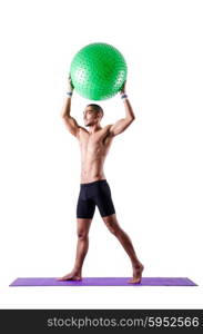 Man with swiss ball doing exercises on white