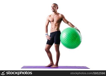 Man with swiss ball doing exercises on white