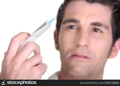 Man with syringe in hand