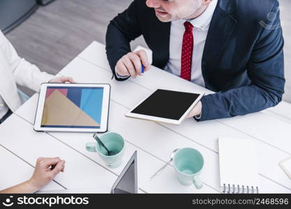 man with tablet chatting with colleagues