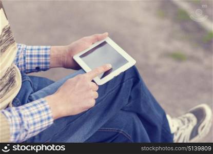 Man with tablet in hand on the street.