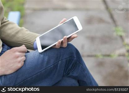 Man with tablet in park.