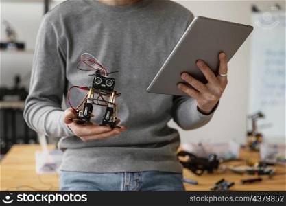 man with tablet learning make robot close up