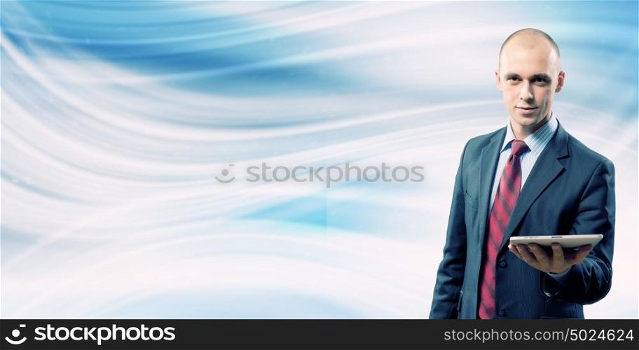 Man with tablet pc. Young handsome businessman holding tablet pc in hand