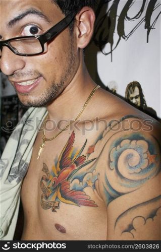 Man with tattoos looking at camera
