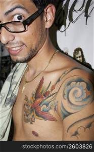 Man with tattoos looking at camera