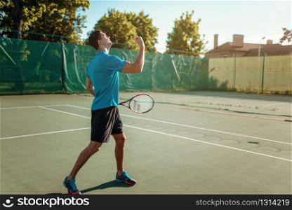 Man with tennis racket on outdoor court. Summer season active sport game. Happy leisure