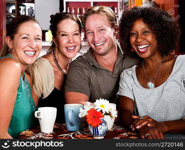 Man with three pretty women in coffee house