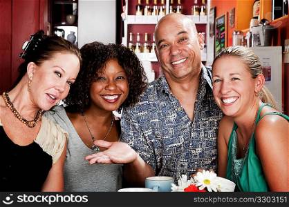 Man with three pretty women in coffee house