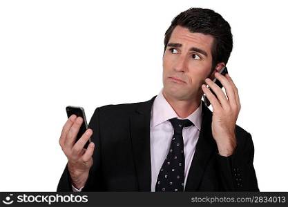 Man with two phones