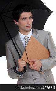 Man with umbrella and folder under his arm