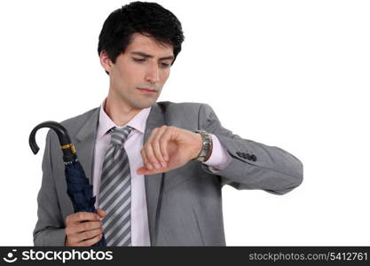 Man with umbrella checking the time