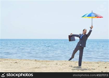 Man with umbrella on beach