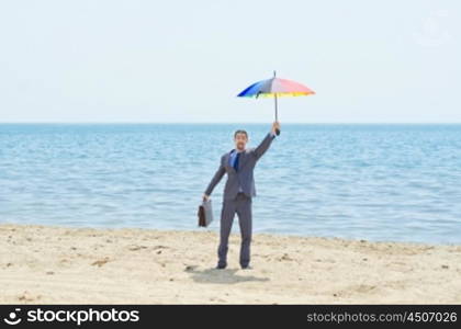 Man with umbrella on beach