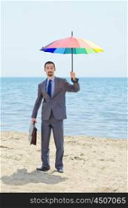 Man with umbrella on beach