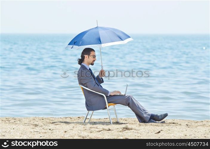 Man with umbrella on seaside beach