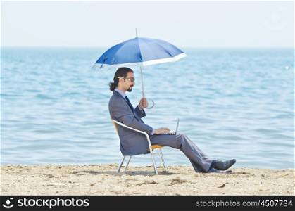 Man with umbrella on seaside beach