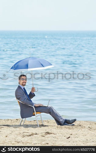 Man with umbrella on seaside beach