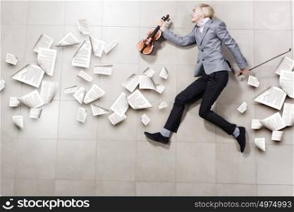 Man with violin. Funny image of running businessman with violin in hand