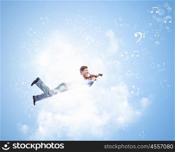Man with violin. Young businessman flying in sky and playing violin
