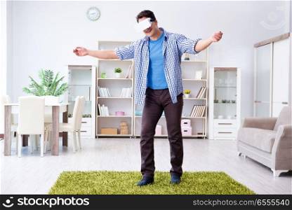 Man with virtual reality glasses playing at home
