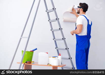 Man with VR glasses gluing wallpaper