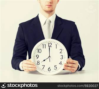 man with wall clock. close up of man holding wall clock