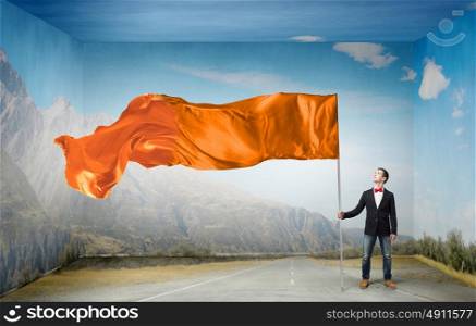 Man with waving flag. Student guy in casual with flag in hands