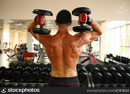 man with weight training equipment on sport gym club &#xA;&#xA;