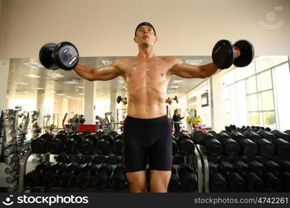 man with weight training equipment on sport gym club &#xA;&#xA;