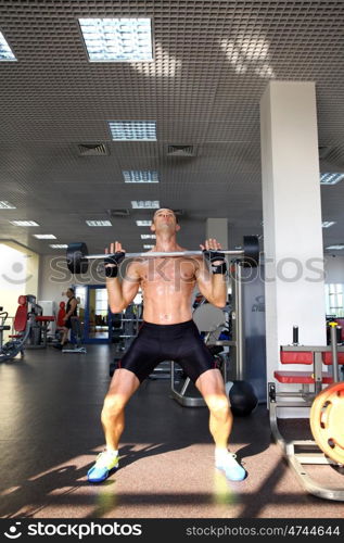 man with weight training equipment on sport gym club &#xA;&#xA;