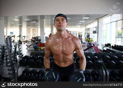 man with weight training equipment on sport gym club &#xA;&#xA;