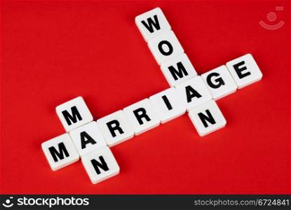 man, woman and marriage words on red background