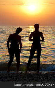 Man, woman and sunset on the sea