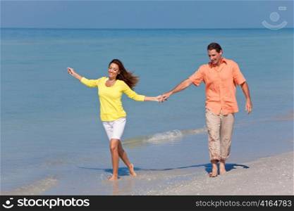 Man & Woman Couple Holding Hands on a Beach