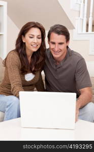 Man & Woman Couple Using Laptop Computer At Home