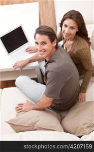 Man & Woman Couple Using Laptop Computer At Home
