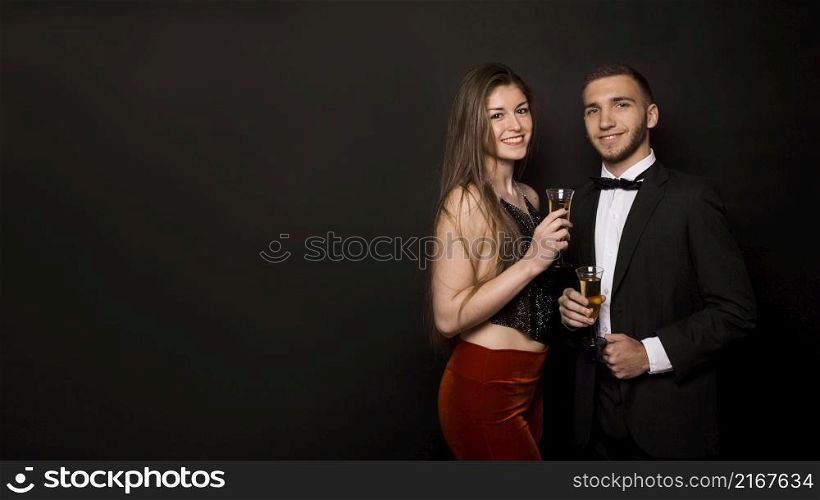 man woman dinner jacket evening wear with glasses drinks