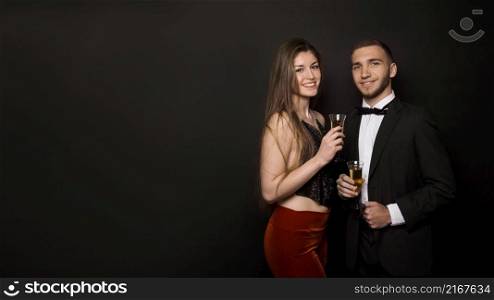 man woman dinner jacket evening wear with glasses drinks